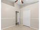This bedroom has a ceiling fan, closet, and tile flooring at 2411 Parsons Pond Cir, Kissimmee, FL 34743