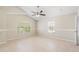 This bedroom has a ceiling fan, carpet, and two windows at 2411 Parsons Pond Cir, Kissimmee, FL 34743