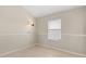 Neutral bedroom with a window, base molding, and tile flooring, ready for personalization at 2411 Parsons Pond Cir, Kissimmee, FL 34743