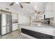 Bright kitchen with stainless steel refrigerator, white cabinets, granite countertops, and a large island at 2411 Parsons Pond Cir, Kissimmee, FL 34743