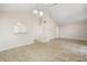 Open concept living room with neutral paint, architectural details and easy access to other areas of the home at 2411 Parsons Pond Cir, Kissimmee, FL 34743