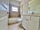 Bright bathroom with tile surround, white vanity and a soaking tub under a window at 2427 Continental Blvd, Orlando, FL 32808