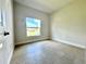 Light-filled bedroom showcasing neutral walls and tile floors with a window overlooking the front yard at 2427 Continental Blvd, Orlando, FL 32808