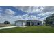 Charming single-story home featuring a well-manicured lawn, a two-car garage, and a covered entryway at 2427 Continental Blvd, Orlando, FL 32808