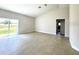 Open-concept living room featuring tile floors, neutral paint, and sliding glass doors at 2427 Continental Blvd, Orlando, FL 32808