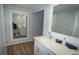 Bathroom features a sleek vanity with sink and a white framed mirror at 2618 Brookside Cir, Mount Dora, FL 32757