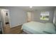 Comfortable bedroom featuring wood flooring and a large window for natural light at 2618 Brookside Cir, Mount Dora, FL 32757