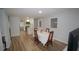 Dining area adjacent to kitchen with white cabinets, breakfast bar, and dining table with chairs at 2618 Brookside Cir, Mount Dora, FL 32757