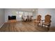 Open floorplan dining area featuring wood-look floors, neutral walls, and large windows to allow natural light at 2618 Brookside Cir, Mount Dora, FL 32757