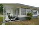Shot of the house front, featuring clean lines, gray accents, and manicured garden at 2618 Brookside Cir, Mount Dora, FL 32757