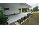 Image captures the side of the home, landscaped area, and ample covered parking at 2618 Brookside Cir, Mount Dora, FL 32757