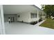 Exterior view showing covered parking area, white siding, and fresh concrete at 2618 Brookside Cir, Mount Dora, FL 32757