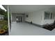 Detailed image of the carport area, displaying lattice design, and freshly painted floor at 2618 Brookside Cir, Mount Dora, FL 32757