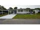 Charming single-story home with covered parking, landscaped yard, and freshly painted driveway at 2618 Brookside Cir, Mount Dora, FL 32757