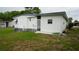 Rear view of white mobile home with gray trim and a screened-in porch at 2618 Brookside Cir, Mount Dora, FL 32757