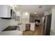 Modern kitchen featuring stainless steel appliances, white cabinets, and open layout to dining area at 2618 Brookside Cir, Mount Dora, FL 32757