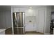 Kitchen featuring stainless steel refrigerator, white shaker cabinets, and laminate flooring at 2618 Brookside Cir, Mount Dora, FL 32757