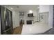Bright kitchen features stainless steel appliances, sleek countertops, and white cabinets at 2618 Brookside Cir, Mount Dora, FL 32757
