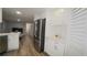 Well-lit kitchen with stainless steel refrigerator and white shaker cabinets, offering ample storage at 2618 Brookside Cir, Mount Dora, FL 32757