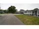 Well maintained street with golf cart and houses with carports at 2618 Brookside Cir, Mount Dora, FL 32757
