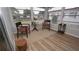 Bright sunroom featuring wood-look floors, neutral walls, and a pair of chairs for comfortable relaxation at 2618 Brookside Cir, Mount Dora, FL 32757