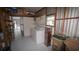 Spacious utility room with a washer and dryer, storage shelves, and access to the outdoors at 2618 Brookside Cir, Mount Dora, FL 32757