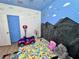 Bright bedroom featuring colorful wall art and play area at 2691 Cypress Tree Trl, St Cloud, FL 34772