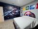 Fun bedroom with a Spiderman mural and a bed with a Captain America headboard at 2691 Cypress Tree Trl, St Cloud, FL 34772