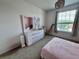 Bright bedroom with a large window, modern vanity, and fun decor at 2691 Cypress Tree Trl, St Cloud, FL 34772