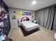 Themed bedroom with vibrant decor, a floating bed, and cozy accents at 2691 Cypress Tree Trl, St Cloud, FL 34772