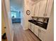 Walk-in butler's pantry includes granite countertops and white cabinets offering ample storage space and easy access to the kitchen at 2691 Cypress Tree Trl, St Cloud, FL 34772