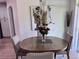Cozy dining room featuring a round table set for four, stylish lighting, and modern decor at 2691 Cypress Tree Trl, St Cloud, FL 34772