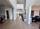 Bright entryway with wood floors that leads to a living space with staircase and office space at 2691 Cypress Tree Trl, St Cloud, FL 34772