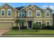 Charming two-story home features a manicured lawn, complemented by fresh landscaping and an attached two car garage at 2691 Cypress Tree Trl, St Cloud, FL 34772