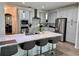 Gourmet kitchen with stainless steel appliances, stone countertops, and a kitchen island with bar stool seating at 2691 Cypress Tree Trl, St Cloud, FL 34772
