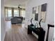 A welcoming living room with a plush gray sofa, bright windows, stylish decor and hardwood flooring at 2691 Cypress Tree Trl, St Cloud, FL 34772