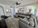 Open-concept living room with archways to the kitchen and dining area, and comfortable seating with lots of space at 2691 Cypress Tree Trl, St Cloud, FL 34772