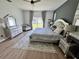 Inviting primary bedroom with queen bed, stylish furnishings, and ample natural light at 2691 Cypress Tree Trl, St Cloud, FL 34772