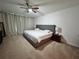 Bright main bedroom features a king-size bed, neutral decor, and lots of natural light at 2691 Cypress Tree Trl, St Cloud, FL 34772