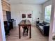 Well lit office space featuring a large rustic table, a cozy couch, and ample natural light at 2691 Cypress Tree Trl, St Cloud, FL 34772