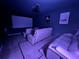 Home theater with large screen, projector, and comfortable reclining seating at 2691 Cypress Tree Trl, St Cloud, FL 34772
