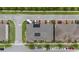 Bird's-eye view highlighting the rooftop solar panels on townhomes, set against a backdrop of community landscaping at 2702 Giardino Loop, Kissimmee, FL 34741