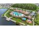 Beautiful aerial shot of the community pool area, complete with lounging spaces and a tranquil lake backdrop at 2702 Giardino Loop, Kissimmee, FL 34741