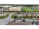 Community overview with modern homes, a well-kept soccer field and modern building at 2702 Giardino Loop, Kissimmee, FL 34741