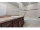Bathroom featuring shower/tub combination and vanity with storage at 2702 Giardino Loop, Kissimmee, FL 34741