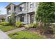 Beautiful townhouse featuring a stone accents, complemented by lush landscaping at 2702 Giardino Loop, Kissimmee, FL 34741