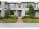 Inviting townhouse with well-kept lawn, featuring a stylish door and ample natural light at 2702 Giardino Loop, Kissimmee, FL 34741