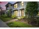 Charming townhouse with stone accents, enhanced by verdant foliage and brick pathway at 2702 Giardino Loop, Kissimmee, FL 34741