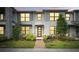 Beautiful modern townhouse featuring a well-manicured lawn and striking architectural details at 2702 Giardino Loop, Kissimmee, FL 34741
