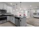 Well-equipped kitchen with stainless steel appliances, open to a naturally lit living area at 2702 Giardino Loop, Kissimmee, FL 34741